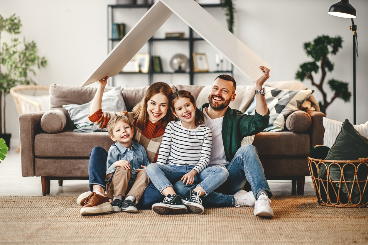 Happy family in a clean living room home showing a concept of healthy life through a clean house